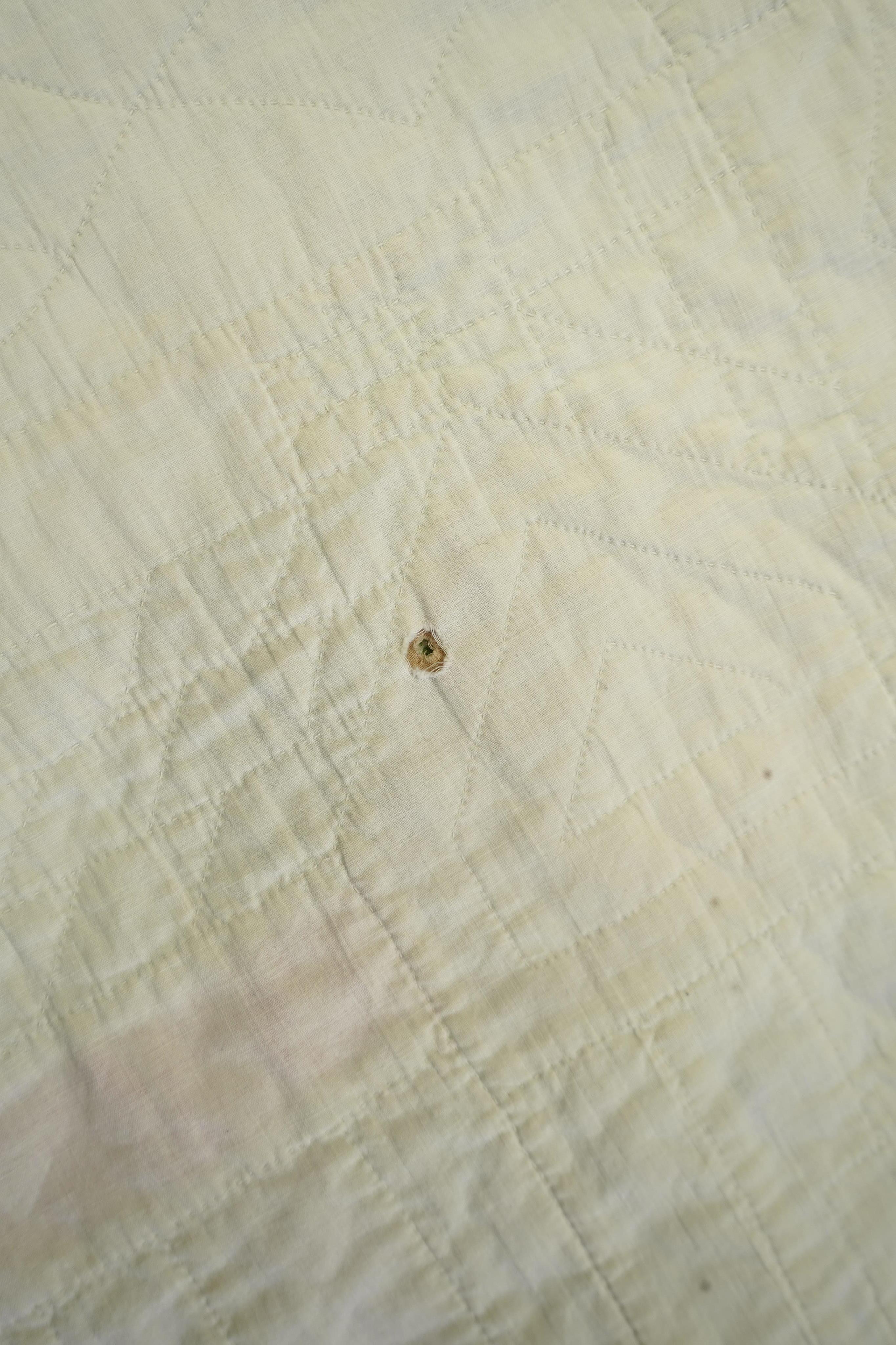 A 1930’s American quilt from Vermont. Quilted in large patchwork ‘house’ motifs, repeating the same four colours in each motif against a plain white background. The reverse a plain white quilted cotton . The quilt hand p